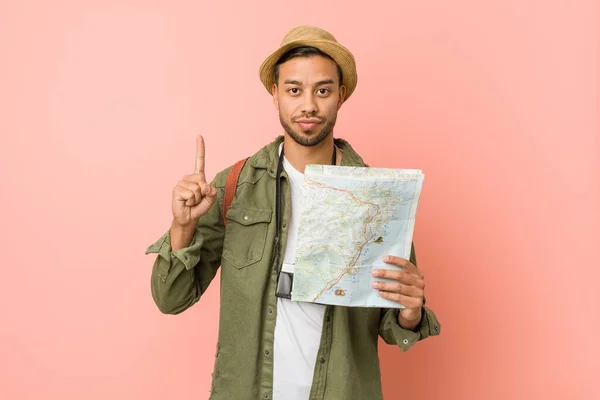 Young south-asian man holding a map