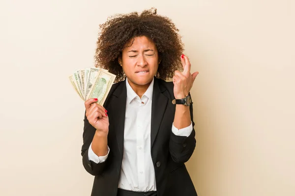 Young African American Woman Holding Dollars Crossing Fingers Having Luck — Stock Photo, Image