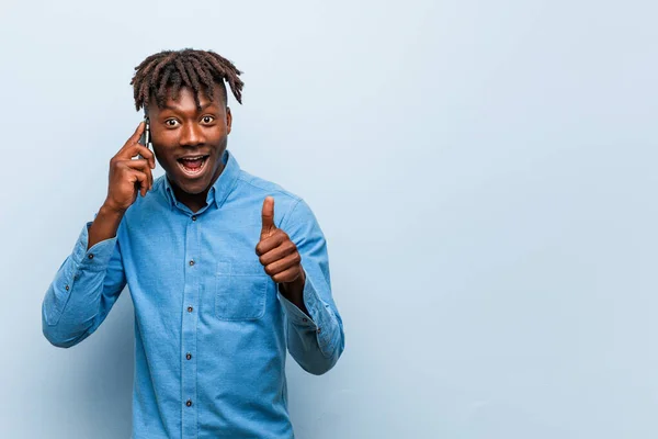 Young Rasta Black Man Holding Phone Smiling Raising Thumb — Stockfoto