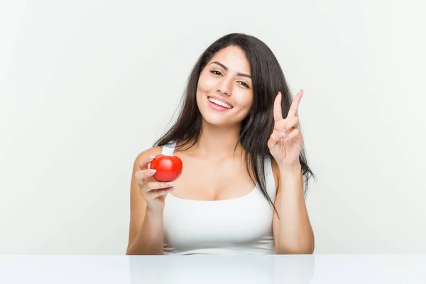 Joven Mujer Hispana Sosteniendo Tomate Mostrando Número Dos Con Los —  Fotos de Stock