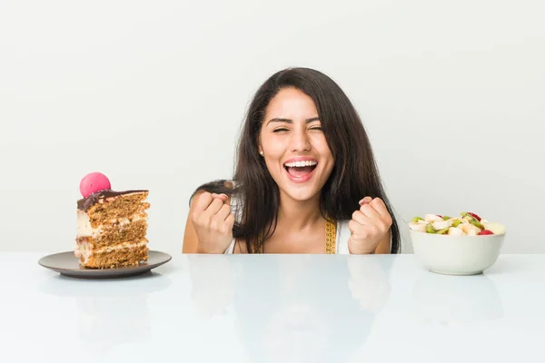 Young Hispanic Woman Choosing Cake Fruit Cheering Carefree Excited Victory — Stok fotoğraf