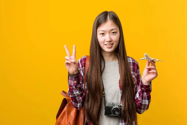 Young Asian Woman Holding Airplane Icon Showing Number Two Fingers — Stock Photo, Image