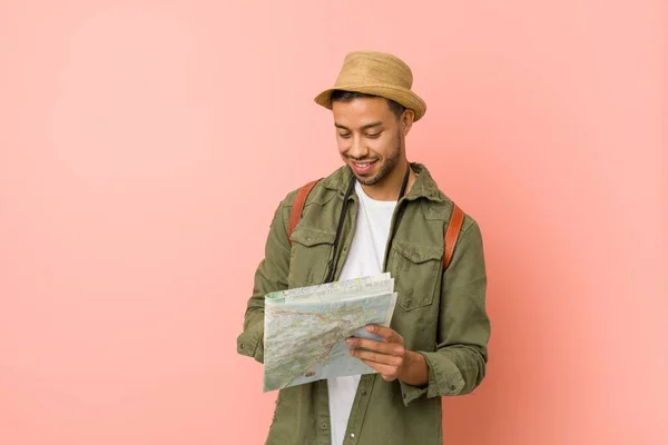 Young south-asian man holding a map