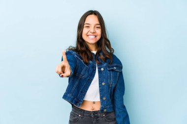 Genç, melez, Latin bir kadın bir numarayı parmağıyla gösteriyor..