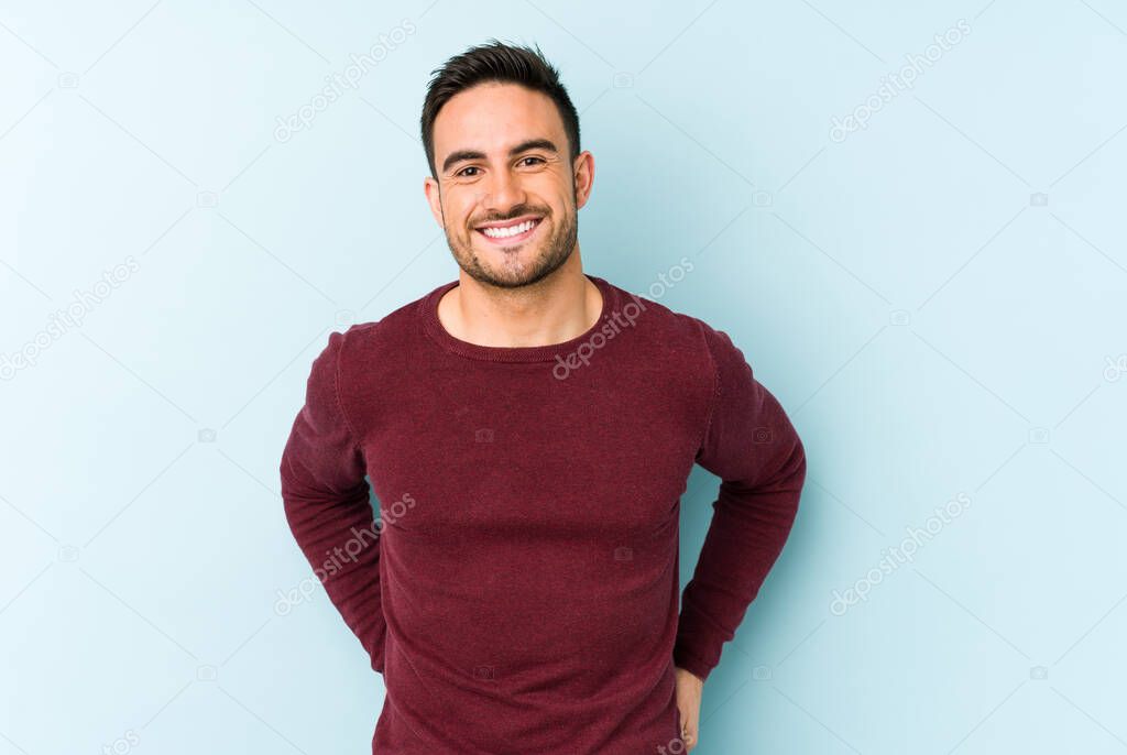 Young caucasian man isolated on blue background happy, smiling and cheerful.