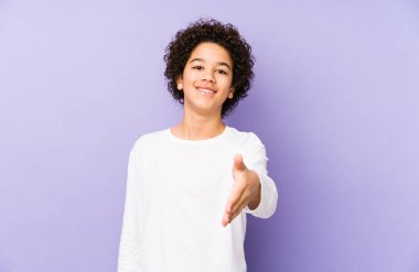 Afrikalı Amerikalı küçük çocuk kameraya elini uzatarak selam veriyor..