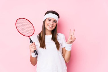 Badminton oynayan beyaz bir kadın iki numarayı parmaklarıyla gösterdi..