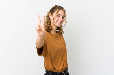 Beyaz sırtlı beyaz kadın neşeli ve kaygısız parmaklarıyla barış sembolü gösteriyor..