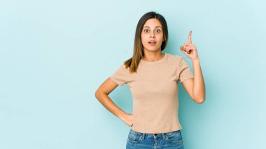 Mavi arka planda izole edilmiş, ağzı açık genç bir kadın..