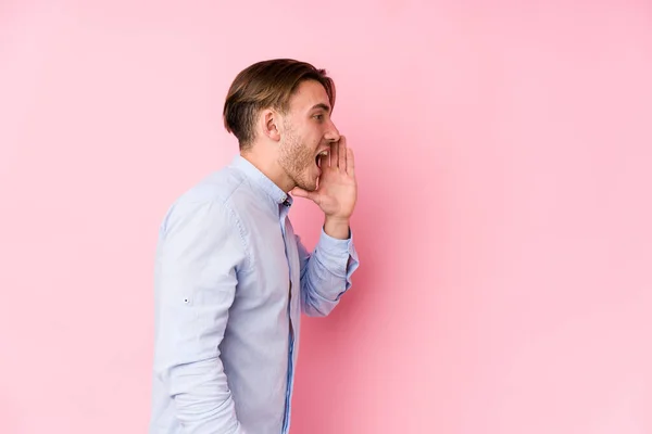 Joven Hombre Caucásico Posando Fondo Rosa Aislado Gritando Sosteniendo Palma — Foto de Stock