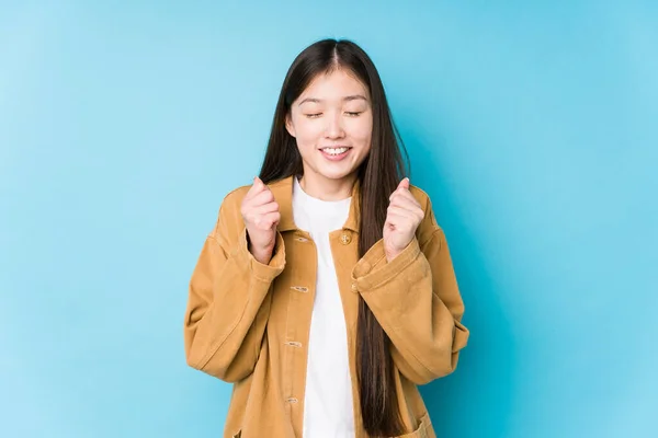 Young Chinese Woman Posing Blue Background Isolated Raising Fist Feeling — Stock Photo, Image