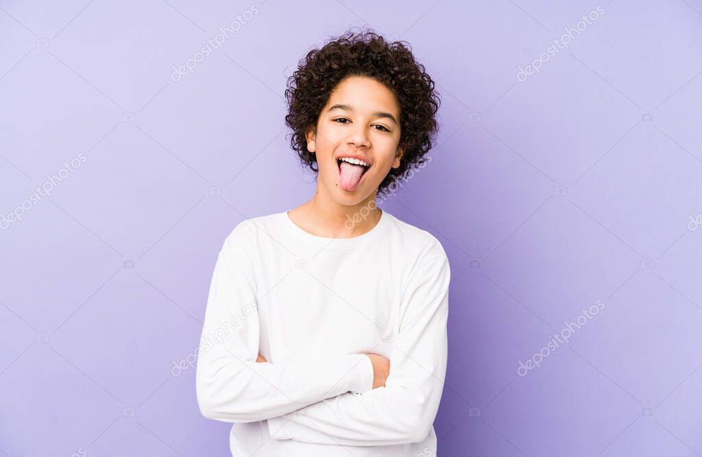 African american little boy isolated funny and friendly sticking out tongue.