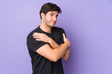 Genç adam mor arka planda yalnızdı. Kucaklaşma, kaygısız gülümseme ve mutluluk..