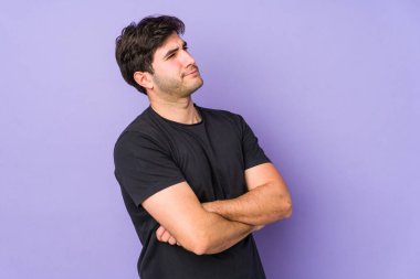 Mor arka planda izole edilmiş genç adam hedeflere ve amaçlara ulaşmayı hayal ediyor.