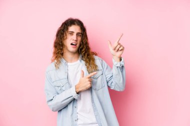 Uzun saçlı adam, izole edilmiş bir şekilde işaret parmağıyla fotokopi odasına işaret ederek heyecan ve arzuyu ifade ediyor..