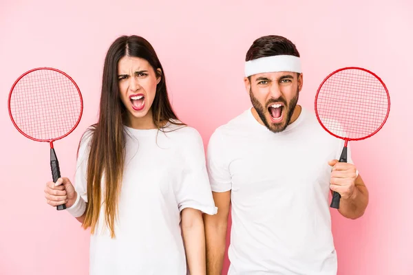 Casal Jovem Jogando Badminton Isolado Gritando Muito Irritado Agressivo — Fotografia de Stock