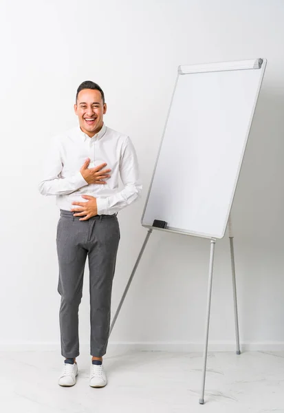 Young Latin Coaching Man Whiteboard Isolated Laughs Happily Has Fun — Stock Photo, Image