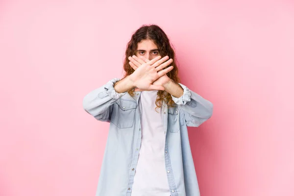 Long hair man posing isolated doing a denial gesture