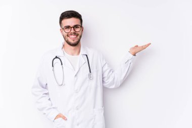 Kafkasyalı genç doktor avucunun içinde bir fotokopi alanı gösterip belinde bir el daha tutuyor..