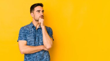 Kafkasyalı genç adam sarı fırında izole edilmiş şüpheli ve şüpheci bir ifadeyle yana bakıyor..