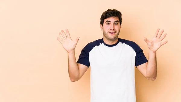 Young Man Isolated Beige Background Receiving Pleasant Surprise Excited Raising — Stock Photo, Image