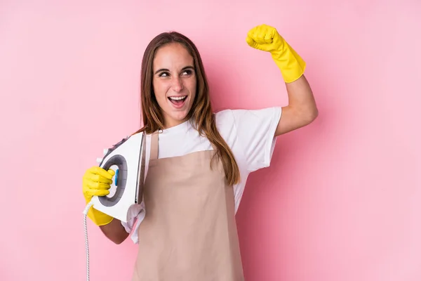 Young Caucasian Woman Clothes Iron Isolated Raising Fist Victory Winner — Stock Photo, Image