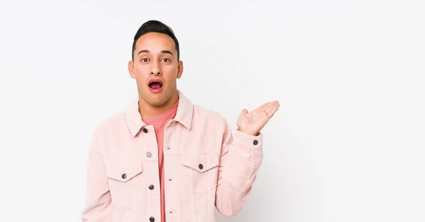 Young Latin Man Posing Isolated Impressed Holding Copy Space Palm — Stock Photo, Image