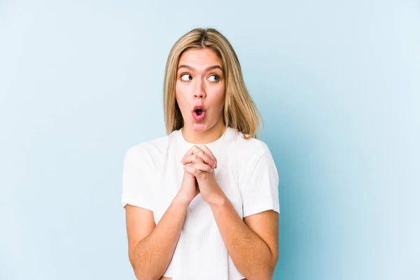 Young Blonde Caucasian Woman Isolated Praying Luck Amazed Opening Mouth — Stock Photo, Image