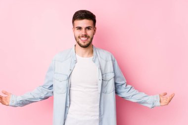 Beyaz arka planda poz veren Kafkasyalı genç iş adamı hoş bir yüz ifadesi sergiliyor.