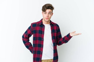 Beyaz arka planda izole edilmiş genç beyaz bir adam bir palmiye üzerinde fotokopi alanı gösteriyor ve belinde başka bir el tutuyor..