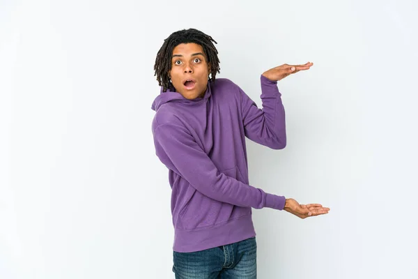 Young African American Rasta Man Shocked Amazed Holding Copy Space — Stock Photo, Image