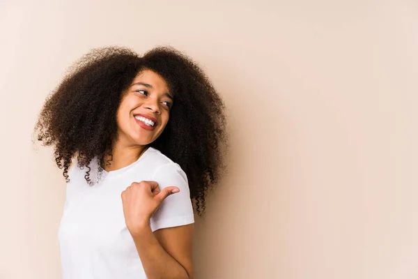 Young African American Woman Points Thumb Finger Away Laughing Carefree — Stock Photo, Image