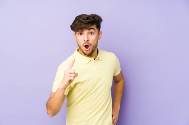 Mor bir arka planda izole edilmiş genç bir Arap adamın bir fikri, ilham konsepti var..