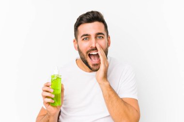 Genç beyaz adam elinde bir nemlendirici ile aloe vera izole edilmiş bağırıyor..