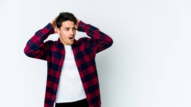 Beyaz arka planda izole olmuş genç beyaz bir adam çığlık atıyor, çok heyecanlı, tutkulu, bir şeyden memnun..