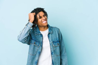 Kot ceket giyen genç siyah bir adam zaferi, tutkuyu ve coşkuyu kutluyor, mutlu bir ifade..