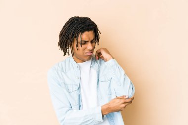 Genç Afrikalı Amerikalı Rasta adam dirsek masajı yapıyor, kötü bir hareketin ardından acı çekiyor..