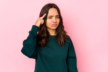 Latin kökenli genç bir kadın tapınağı işaret ediyor, düşünüyor ve bir göreve odaklanıyor..