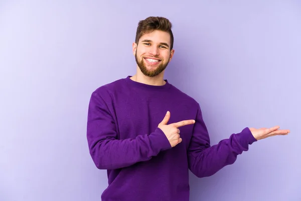 Young Caucasian Man Isolated Purple Background Excited Holding Copy Space — Stock Photo, Image