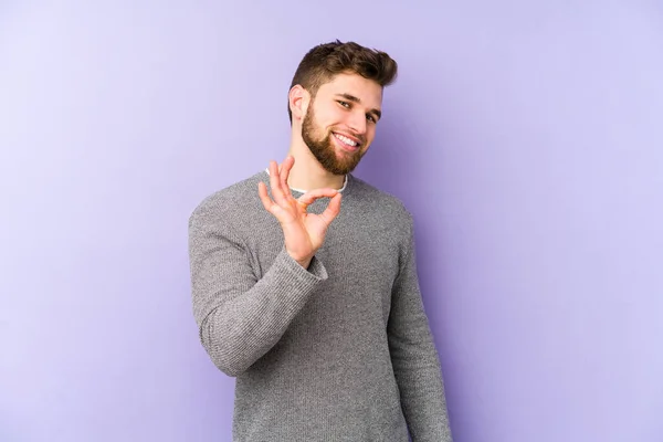 Homem Caucasiano Jovem Isolado Fundo Roxo Pisca Olho Mantém Gesto — Fotografia de Stock