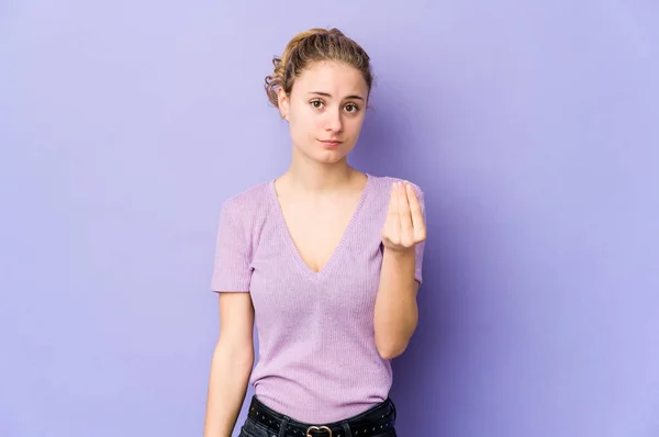 Young caucasian woman on purple background showing that she has no money.