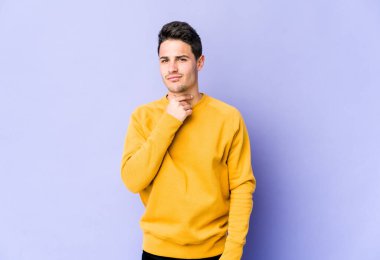 Mor arka planda izole edilmiş genç beyaz bir adam virüs veya enfeksiyon yüzünden boğazında ağrı hissediyor..