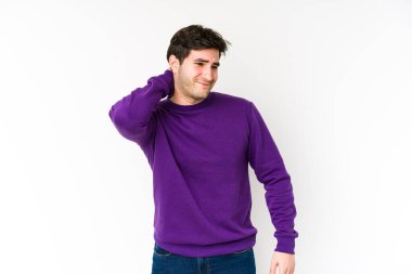 Genç adam beyaz arka planda izole edilmiş kafasının arkasına dokunuyor, düşünüyor ve bir seçim yapıyor..