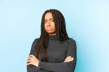 Young african american woman isolated on blue background unhappy looking in camera with sarcastic expression. clipart