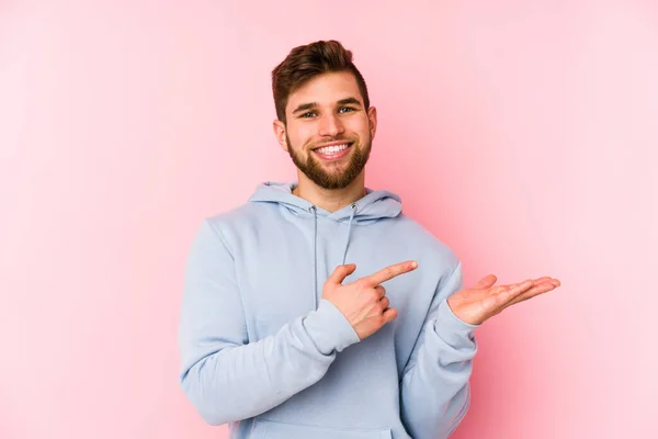 Young Caucasian Man Isolated Pink Background Excited Holding Copy Space — Stock Photo, Image