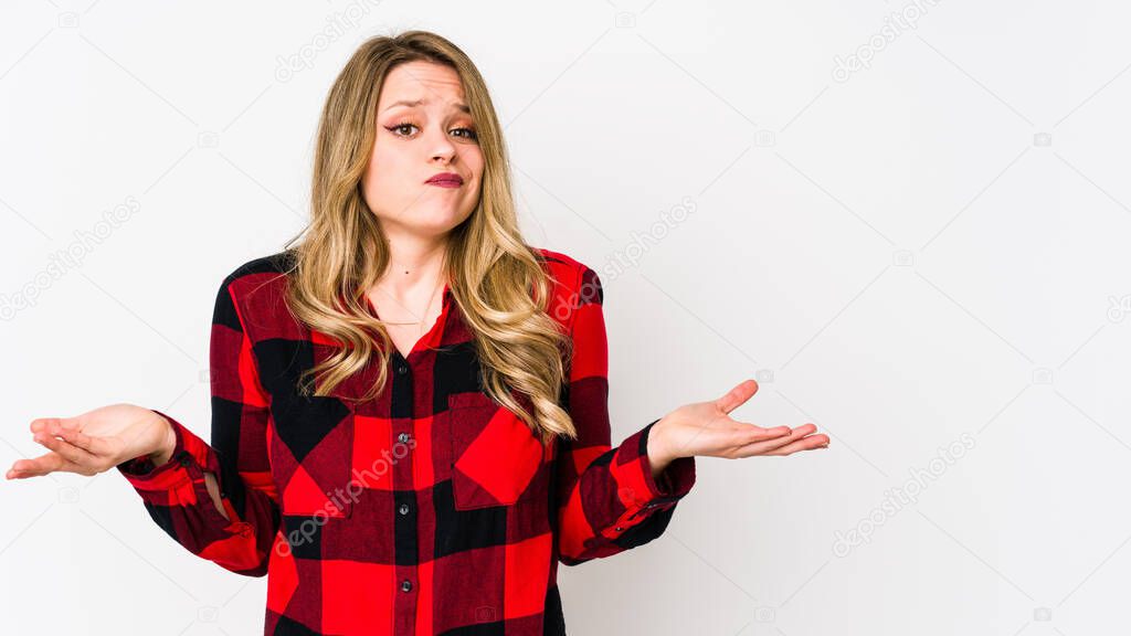 Young cauciasian woman isolated on white background doubting and shrugging shoulders in questioning gesture.