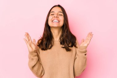 Genç, melez, Latin bir kadın. Kahkahalar atıyor, elini göğsüne koyuyor..