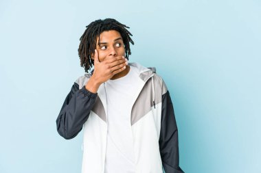 Genç Afro-Amerikan sporcu düşünceli bir şekilde bir fotokopi odasına bakıyor ağzını eliyle kapatıyor..