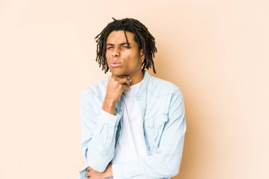 Genç Afrikalı Amerikalı Rasta adam bir virüs veya enfeksiyon yüzünden boğaz ağrısı çekiyor..
