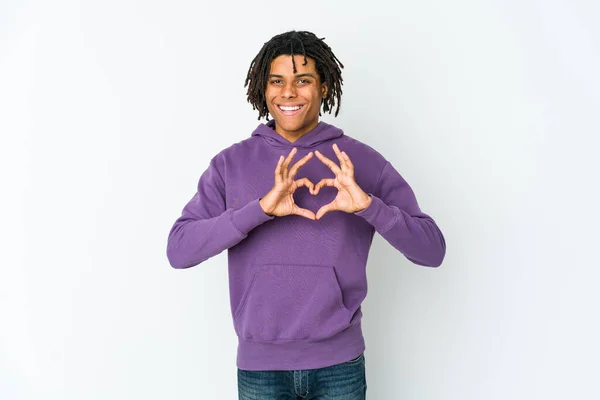 Young african american rasta man smiling and showing a heart shape with hands.